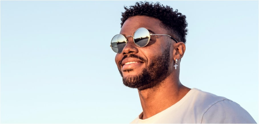 a man smiling with glasses