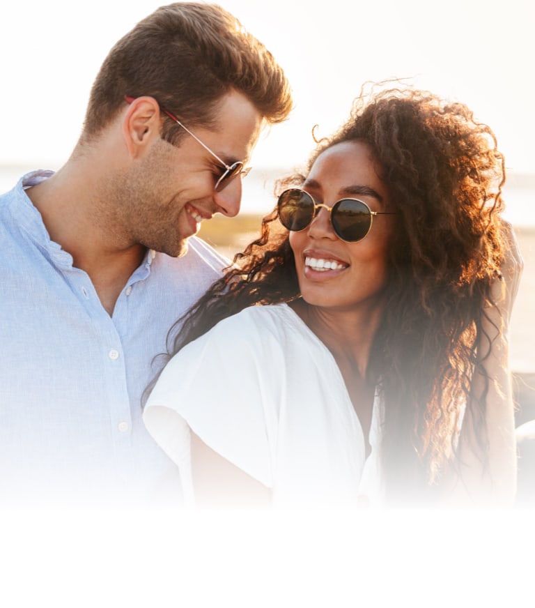 two people smiling wearing sunglasses