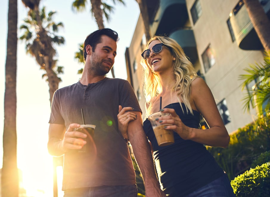 a couple smiling and walking